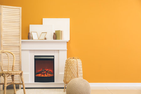 Fireplace with wooden screen in stylish interior of roomの写真素材
