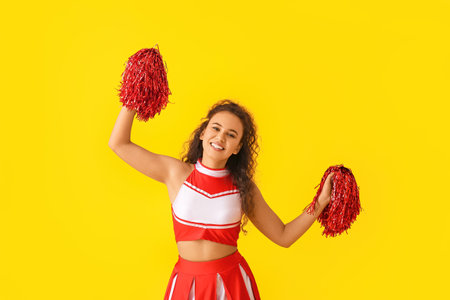 Beautiful young cheerleader on color backgroundの写真素材