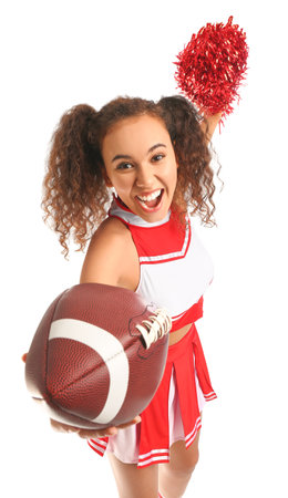 Beautiful young cheerleader with ball on white backgroundの写真素材