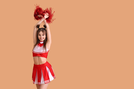 Beautiful young cheerleader on color backgroundの写真素材