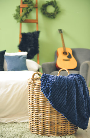 Basket with blanket in interior of stylish bedroomの写真素材