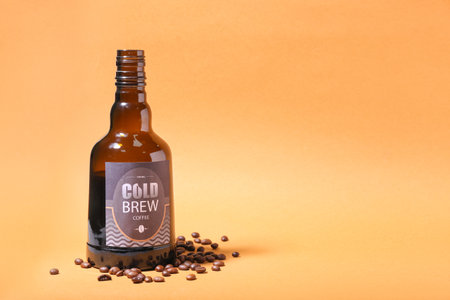 Bottle of cold brew and coffee beans on color backgroundの写真素材