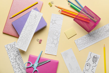 Cute bookmarks with stationery on color background