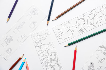 Cute bookmarks with pencils on white backgroundの写真素材