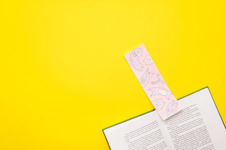 Book with bookmark on color background