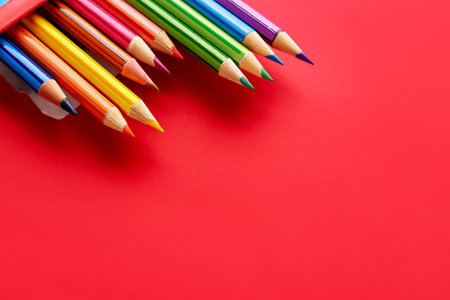 Set of colorful pencils on red backgroundの写真素材