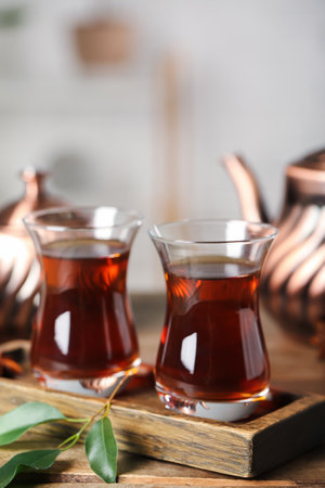Board with cups of Turkish tea on wooden table, closeupの写真素材