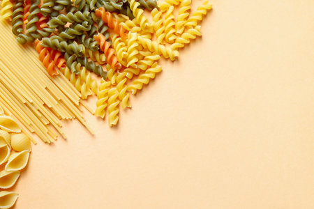 Assortment of raw pasta on color backgroundの写真素材