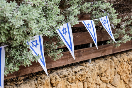Wooden fence with flags of Israel outdoors, closeupの写真素材