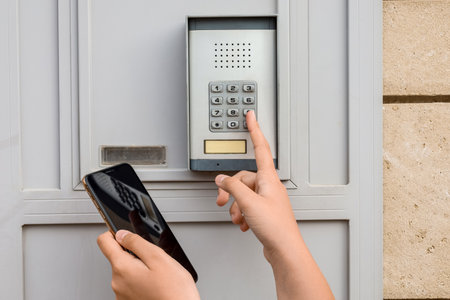 Child with mobile phone using intercom outdoors, closeup