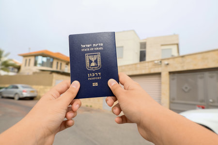 Child with passport of Israel in city, closeupの写真素材