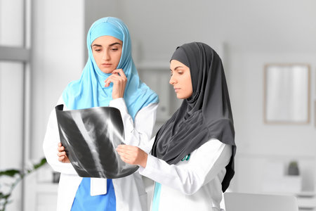 Portrait of Muslim female doctors with x-ray scan in clinicの写真素材