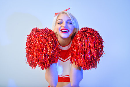 Beautiful cheerleader on color background