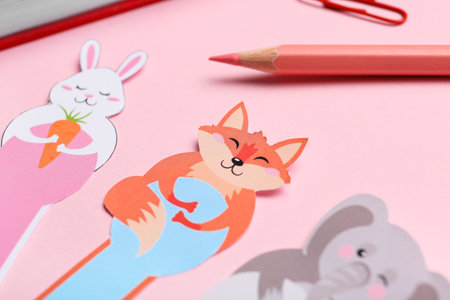 Cute bookmarks on color background, closeup