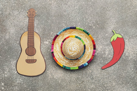 Mexican sombrero, drawn guitar and chili pepper on grunge background