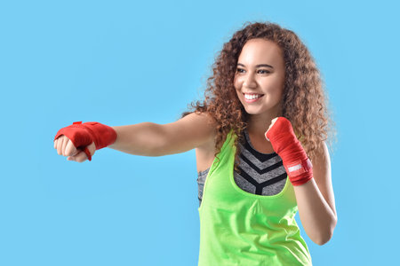 Beautiful young woman training on color background