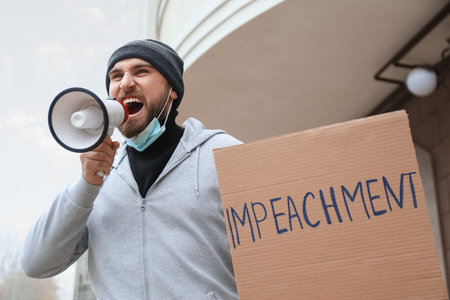 Protesting man outdoors. impeachment concept