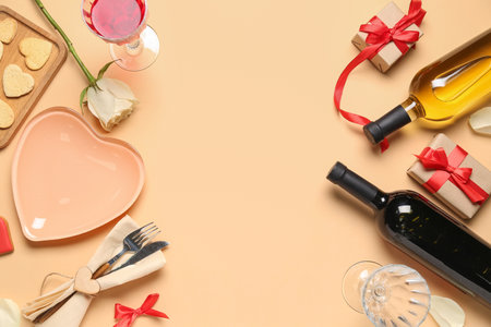 Composition with bottles of wine, plate, cutlery and gifts for Valentine's Day celebration on color backgroundの写真素材