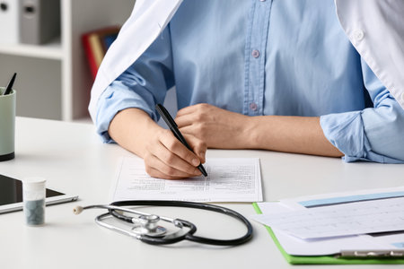 Female doctor writing prescription in clinicの写真素材