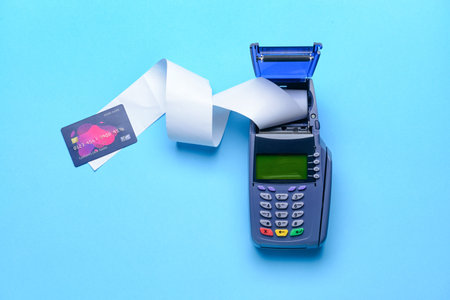 Payment terminal with credit card on color background