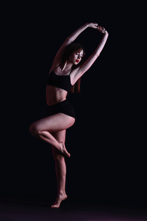 Beautiful young woman in underwear on dark backgroundの写真素材