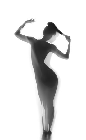 Silhouette of beautiful sexy woman behind curtain on white backgroundの写真素材