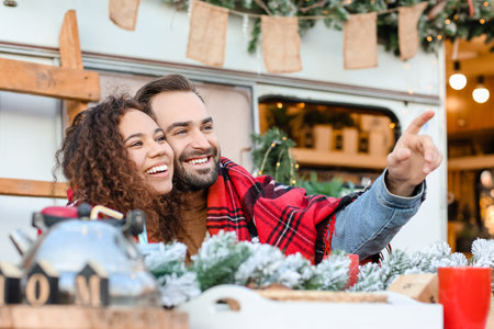 Happy young couple celebrating Christmas outdoorsの写真素材