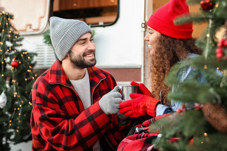 Happy young couple celebrating Christmas outdoorsの写真素材
