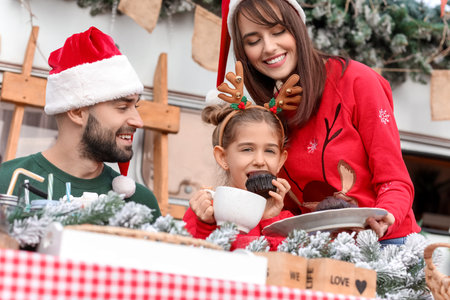 Happy family celebrating Christmas outdoorsの写真素材