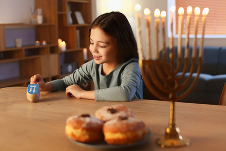 Happy little girl celebrating Hannukah at homeの写真素材