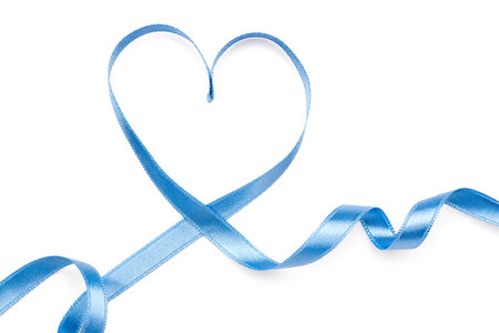 Heart made of blue satin ribbon isolated on white background. Valentine's Day celebrationの写真素材