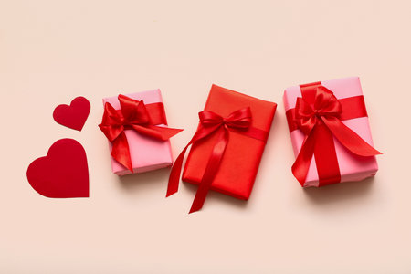 Beautiful gifts and paper hearts on white background. Valentine's Day celebrationの写真素材