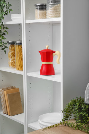 Geyser coffee maker and groceries on shelf in kitchenの写真素材