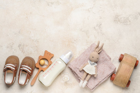 Bottle of milk for baby and accessories on gray backgroundの写真素材