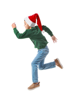 Jumping little boy in Santa hat on white backgroundの写真素材