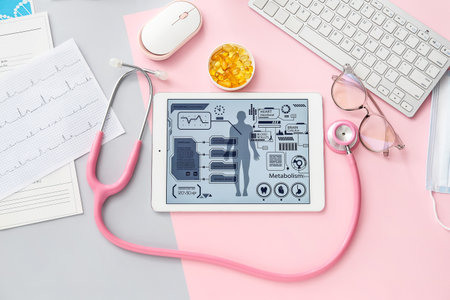 Tablet computer with stethoscope, pills, cardiogram and accessories of doctor on color background