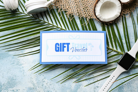Travel gift voucher, headphones and smartwatch on color backgroundの写真素材