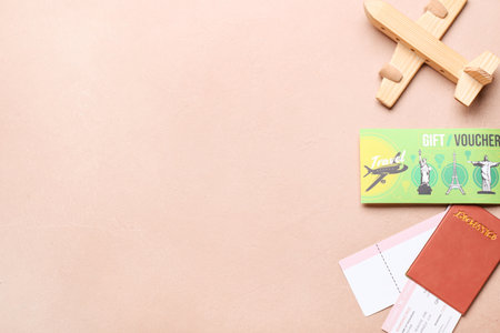 Wooden airplane, passport with tickets and travel gift voucher on color backgroundの写真素材
