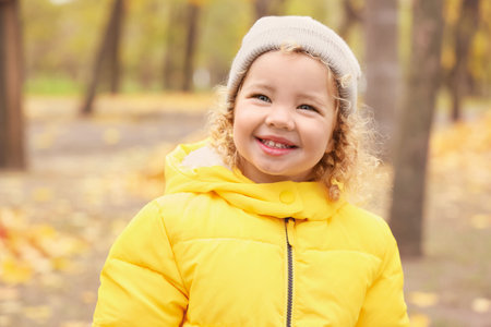 Cute little girl in autumn parkの写真素材