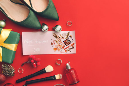 Gift certificate, decorative cosmetics and female accessories on color background