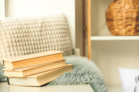 Old books on window sill in roomの写真素材