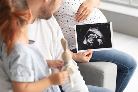 Pregnant Asian woman with her family at homeの写真素材