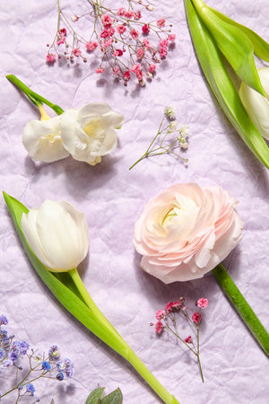 Composition with beautiful spring flowers on crumpled paper background