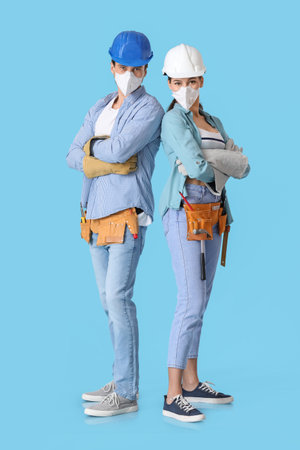 Happy couple with repair tools on color backgroundの写真素材