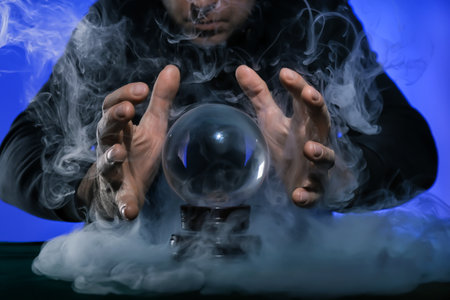 Fortune teller with crystal ball at tableの写真素材
