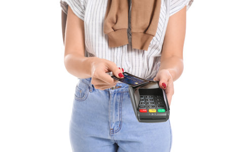 Young woman with payment terminal and credit card on white background