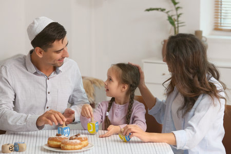 Happy family celebrating Hannukah at homeの写真素材