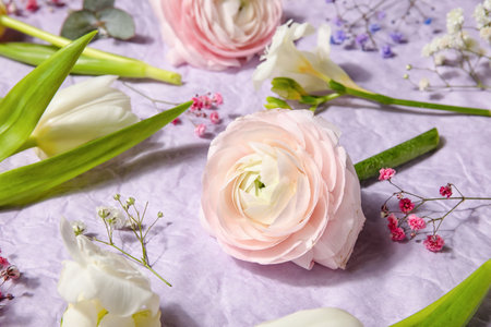 Composition with beautiful spring flowers on crumpled paper backgroundの写真素材