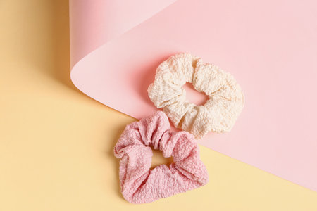 Stylish scrunchies on color background