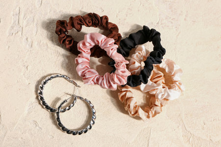 Set of scrunchies with earrings on light backgroundの写真素材